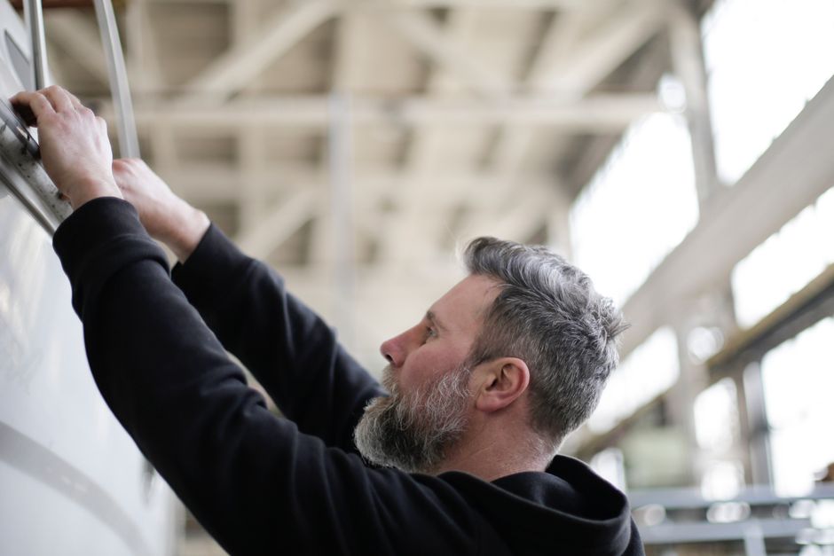 overhead garage door metal cable drum track technician repair — garage door repair in Lafayette, LA